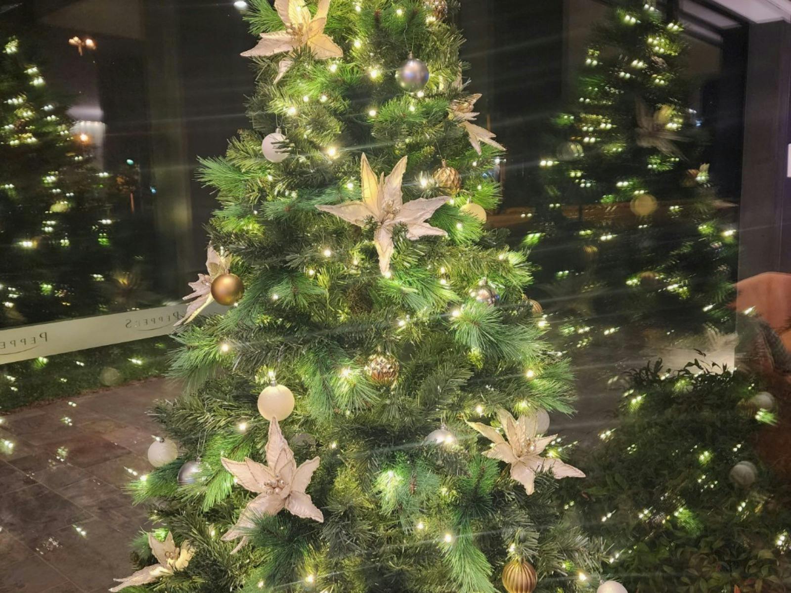 a christmas tree decorated with tinsel and fairy lights