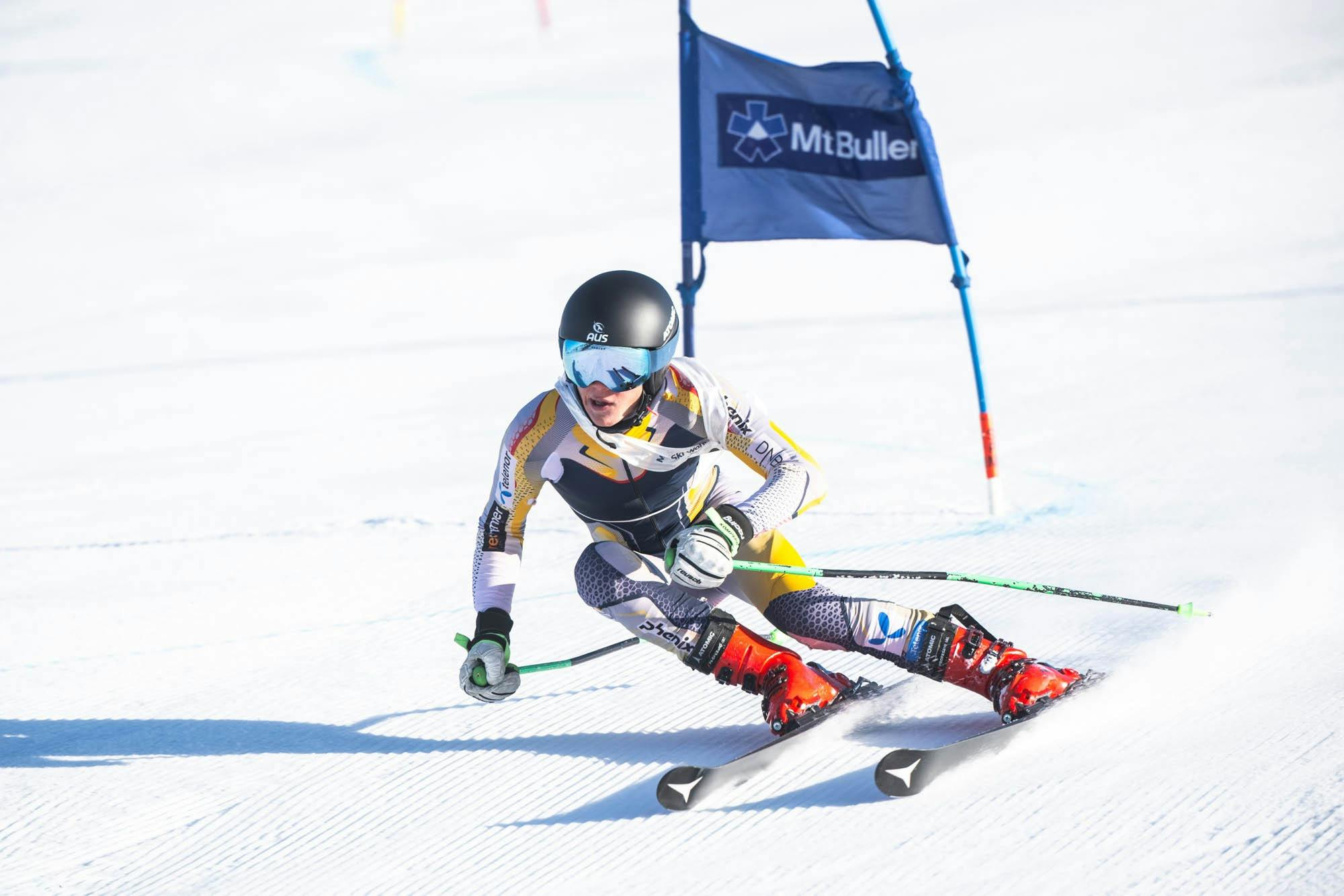 Ski Racer bending while skiing in the snow