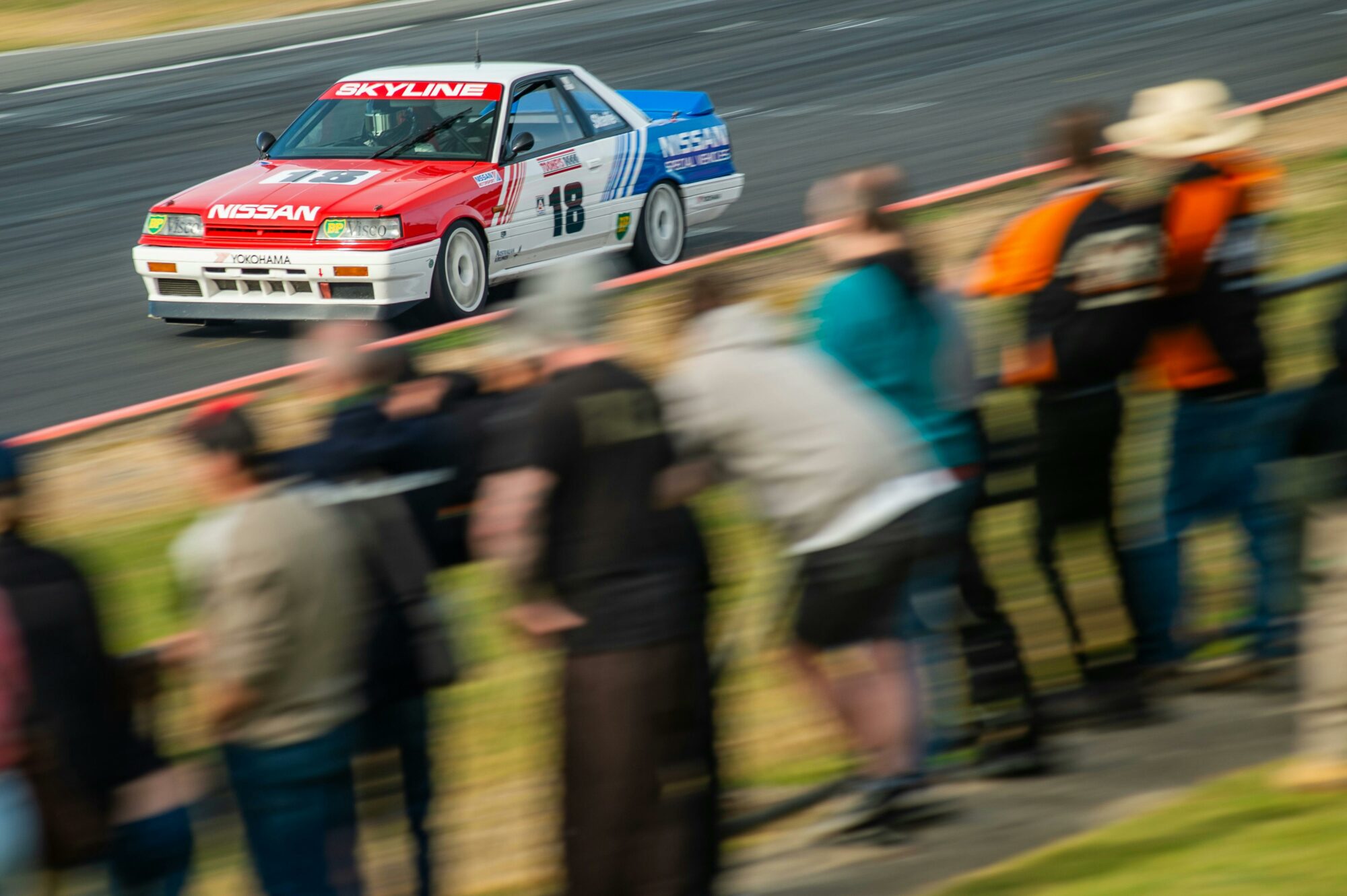 Race car going past spectators
