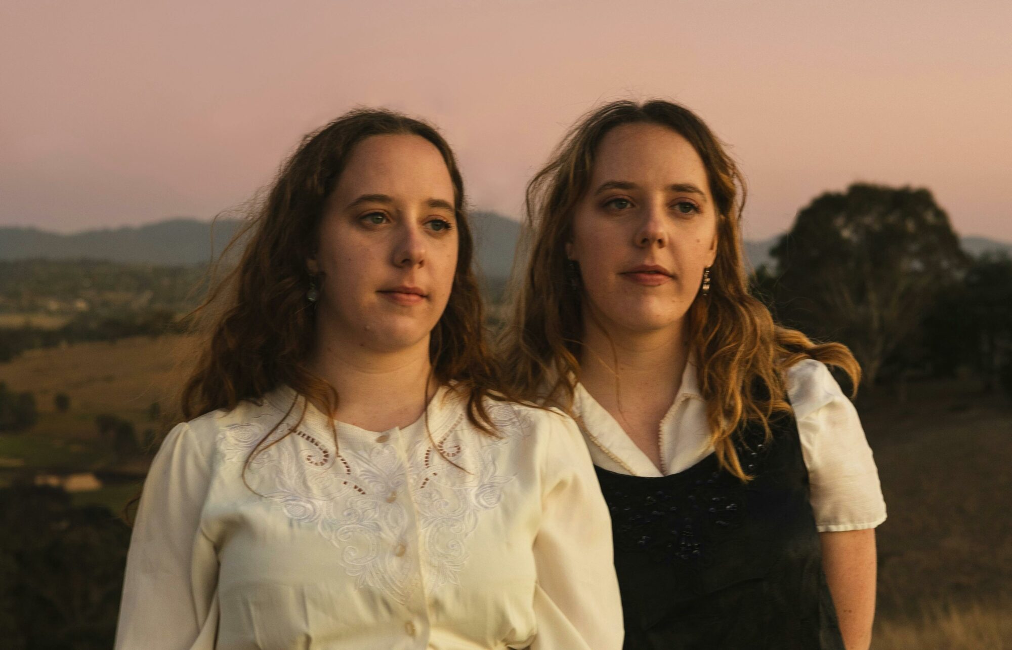 Two sisters portrait, looking to the distance