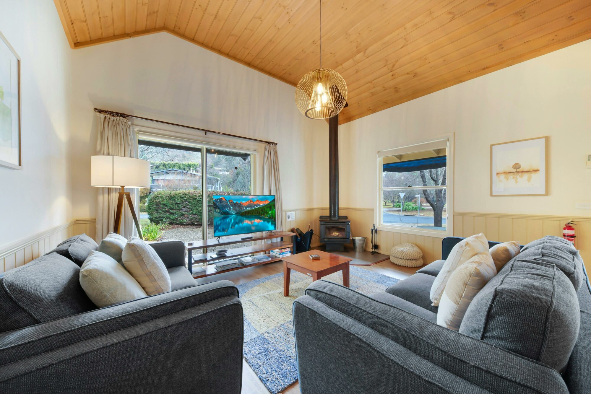 Lounge area with a small fireplace, television, couches and tea table