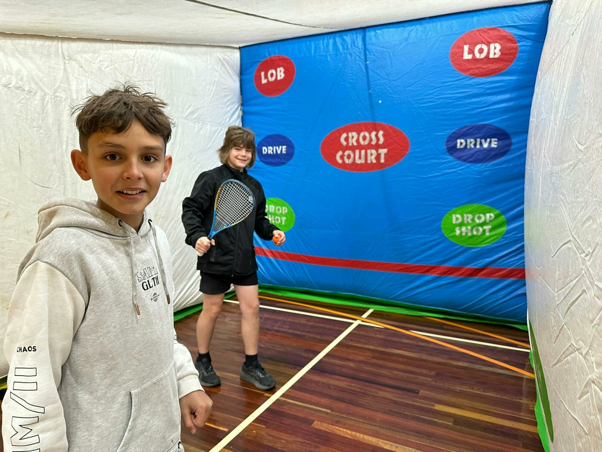 Two boys playing squash