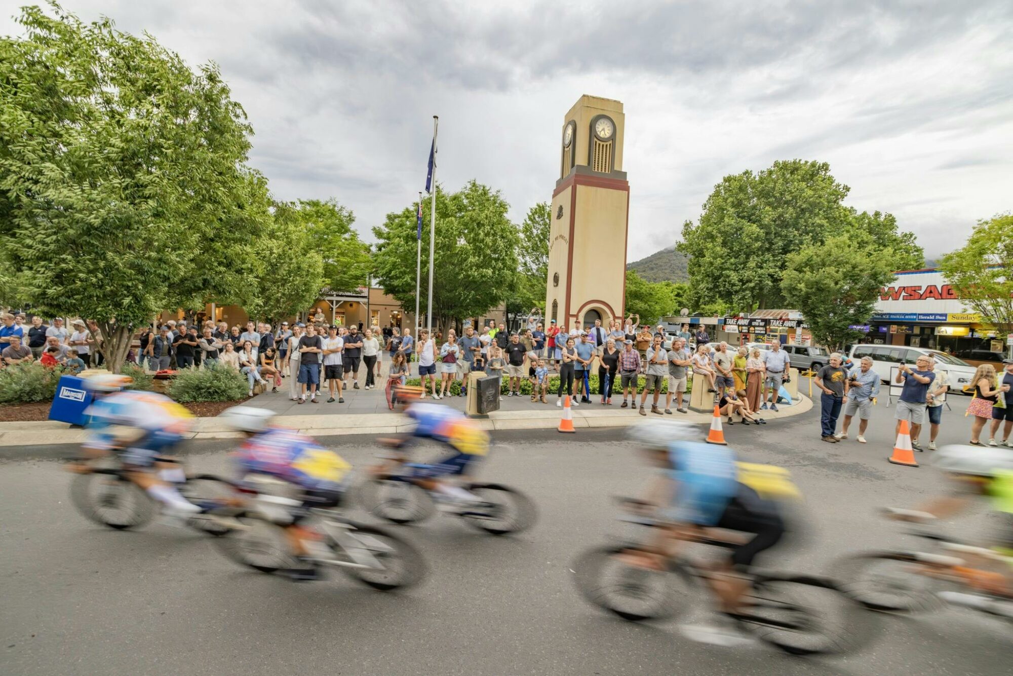 Crowd watches are cyclists ride past them