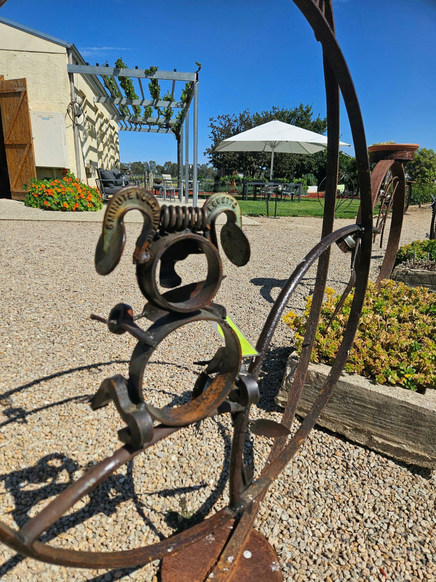 metal koala in front of umbrella