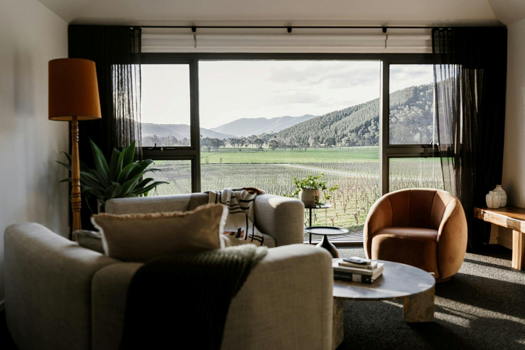 interior of Marsden with couches and floor to ceiling windows looking onto the winery and hills