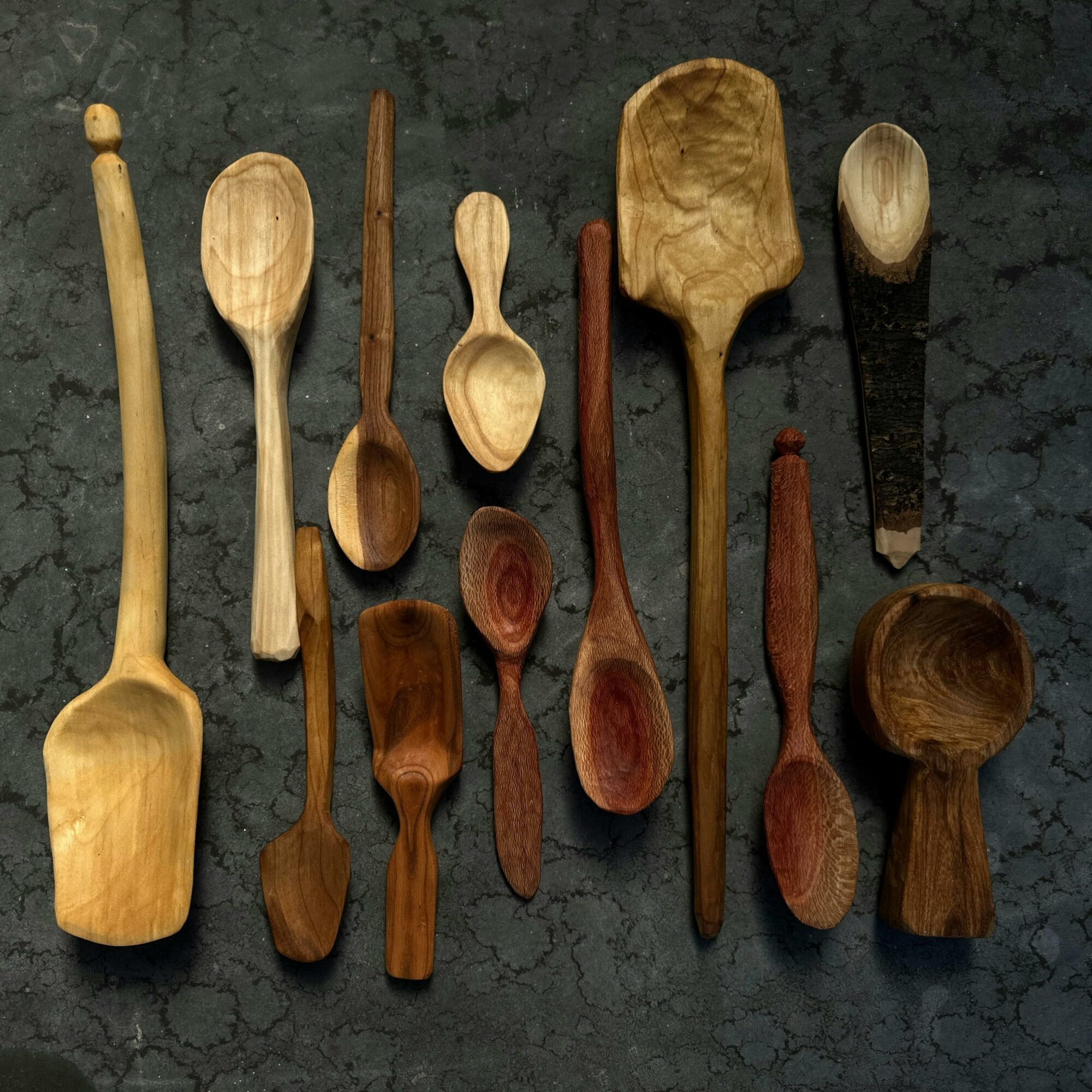 a hand-made wooden spoon with two carving knives