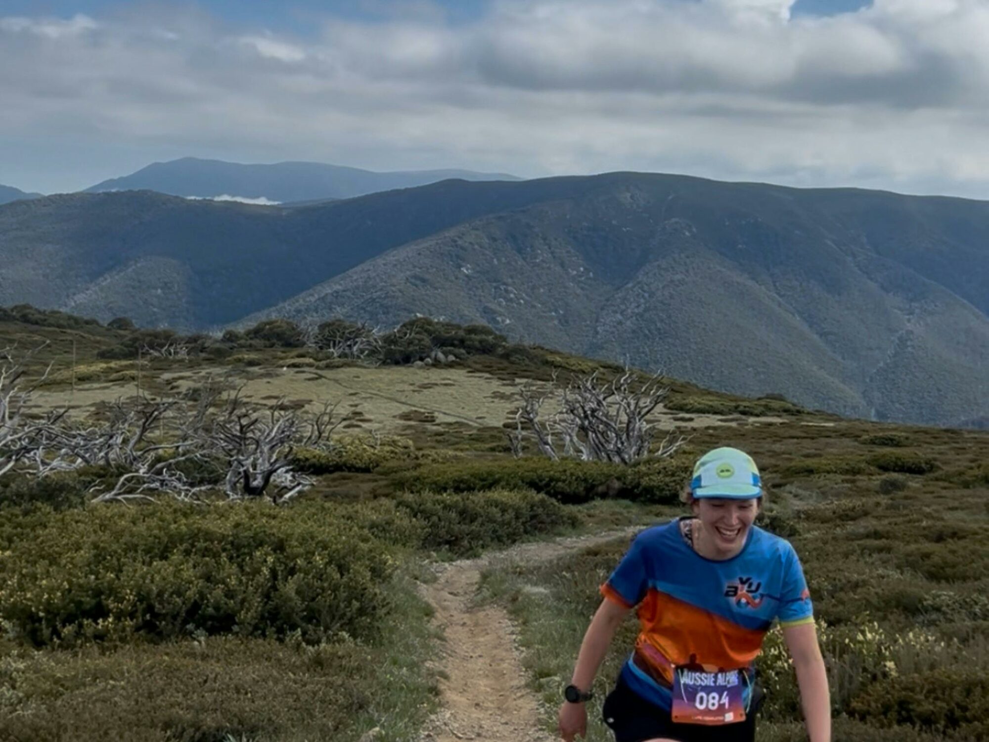 A sole participant hiking up the mountain with a landscape mountain fiew as backdrop