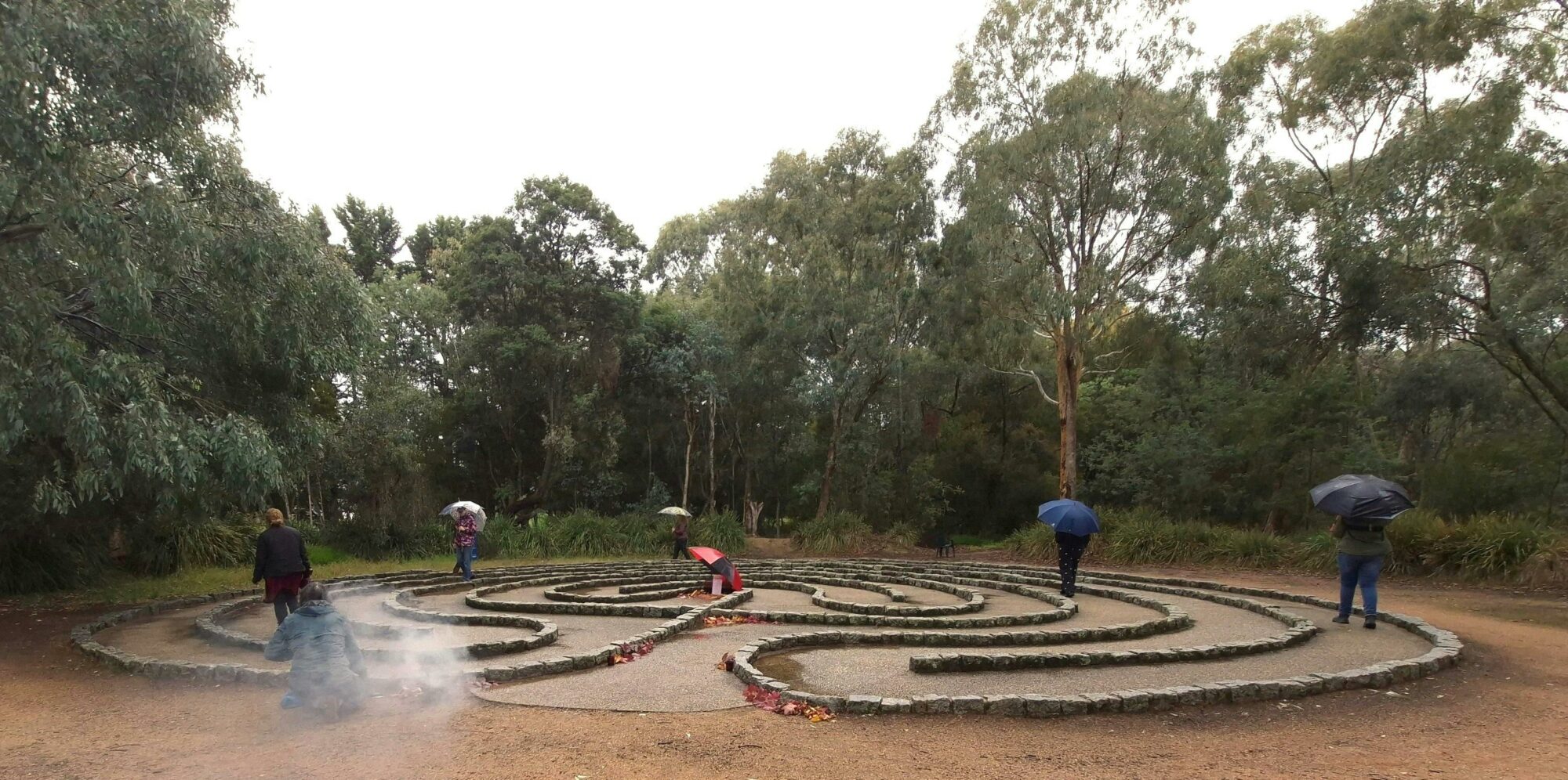 Participants walking a stone labyrinth during an outdoor Labyrinth Ritual Walk in Beechworth