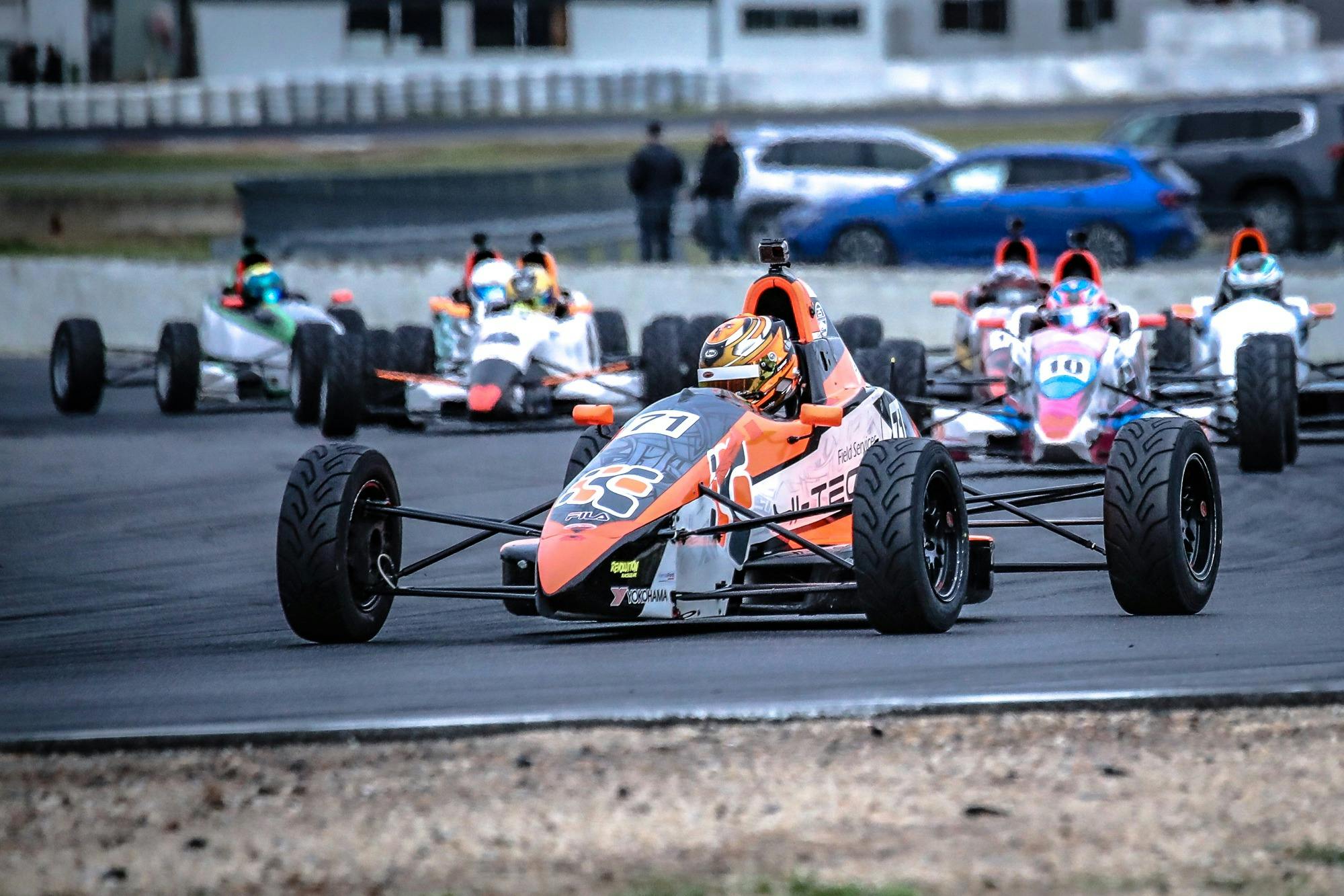 Open wheel race cars on a race track