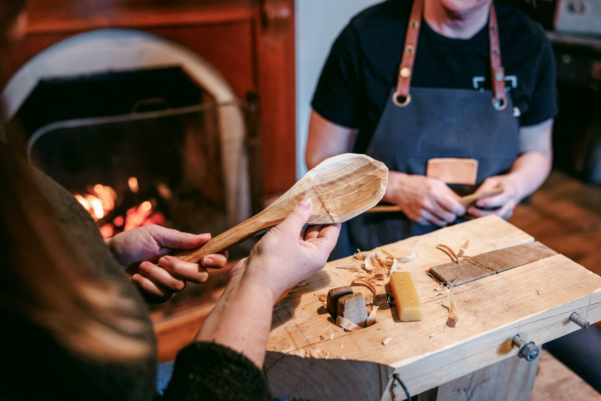 close up of hand carving a wooden spoon
