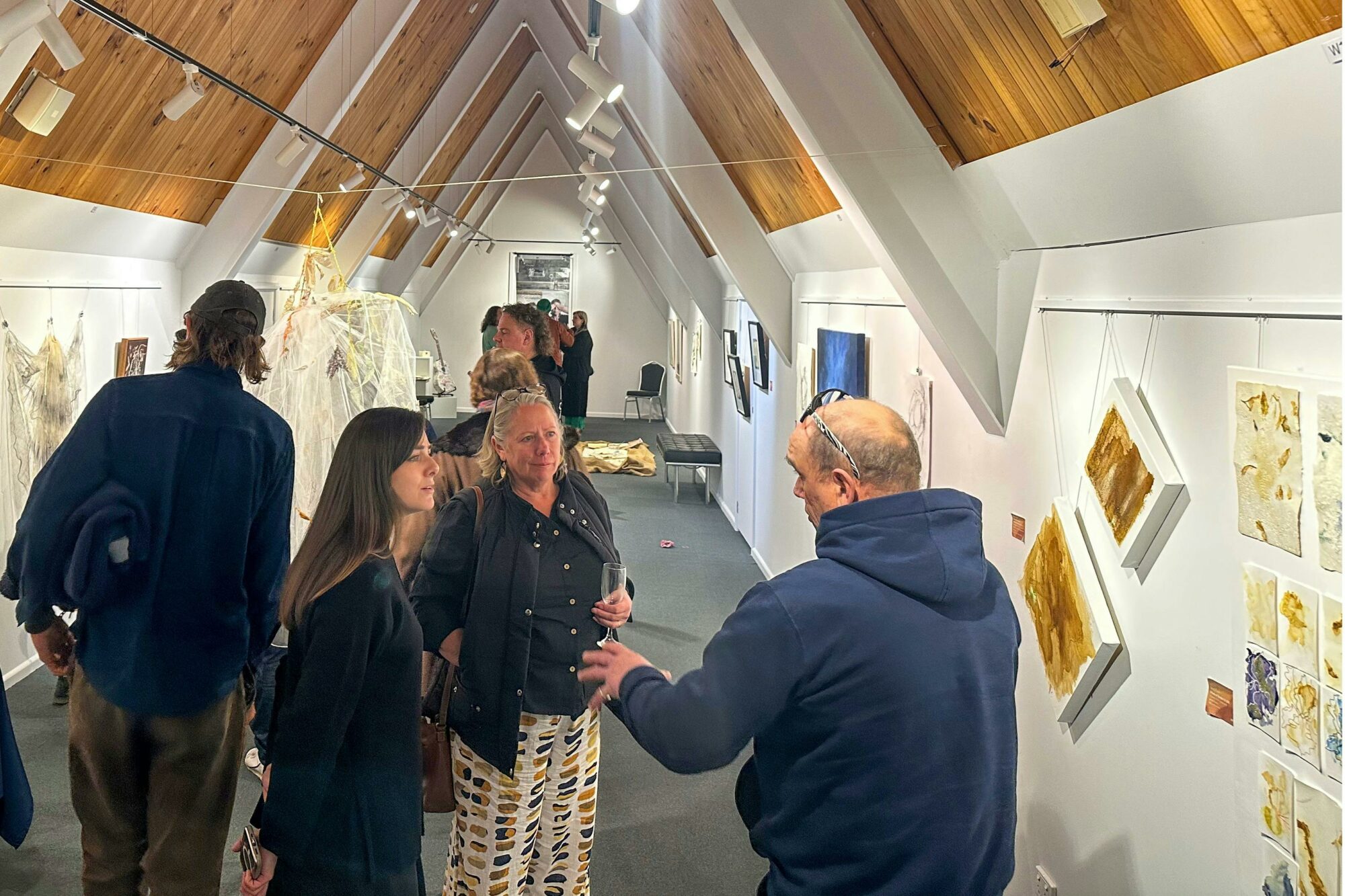 A group of people at an art exhibition opening