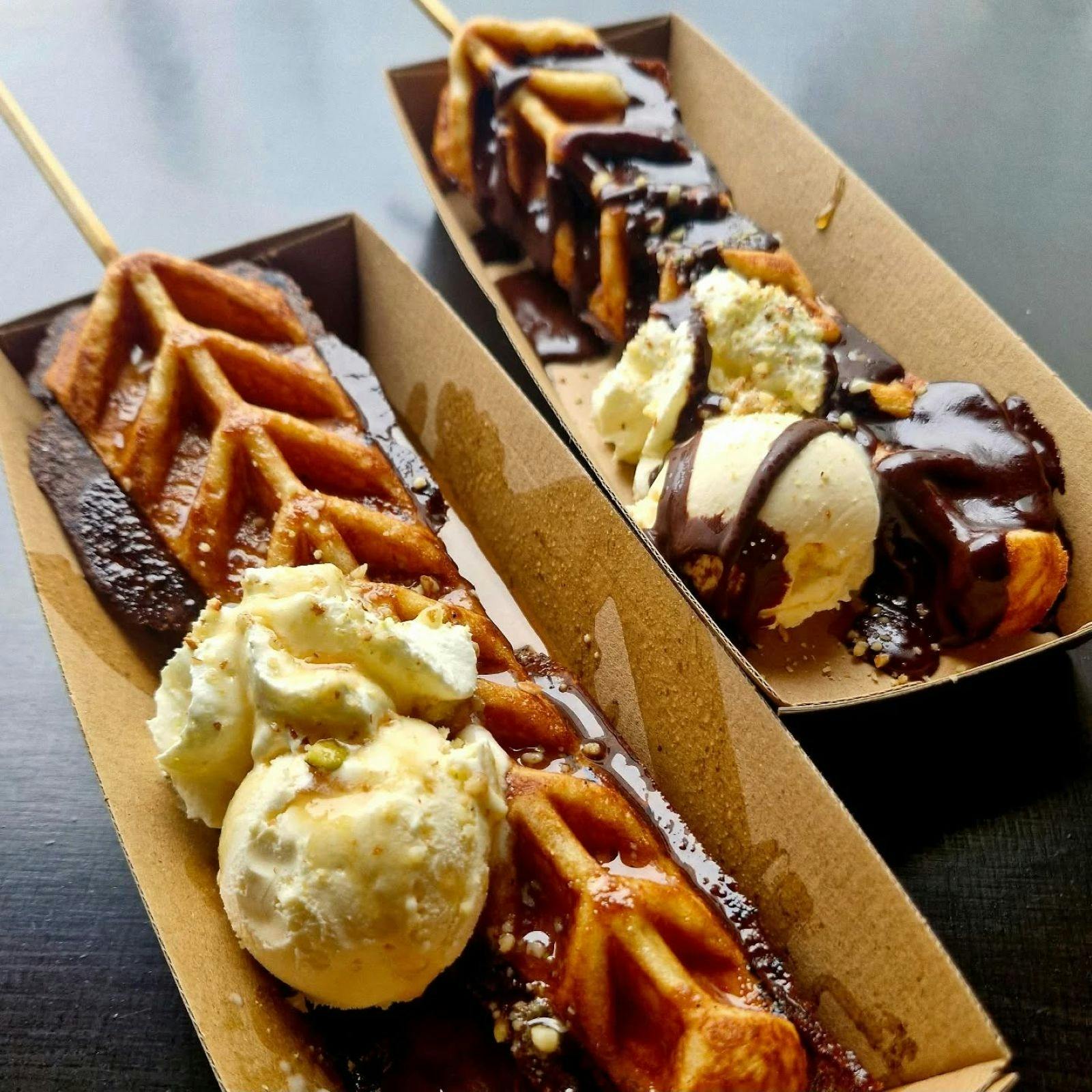 Waffle on a stick and ice cream with chocolate sauce