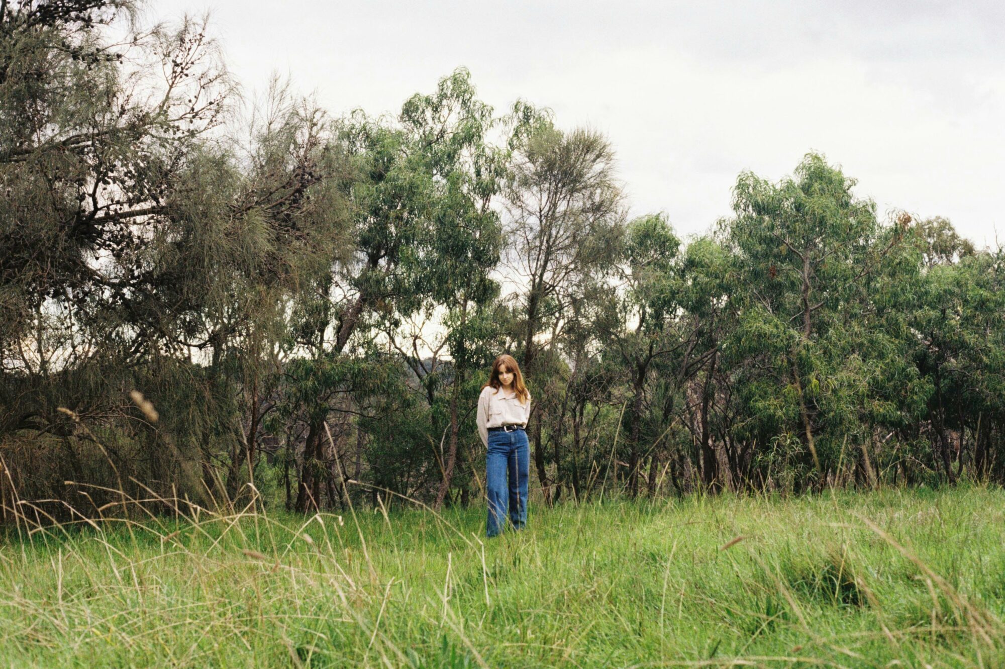 Georgie Currie standing in a bush landscape