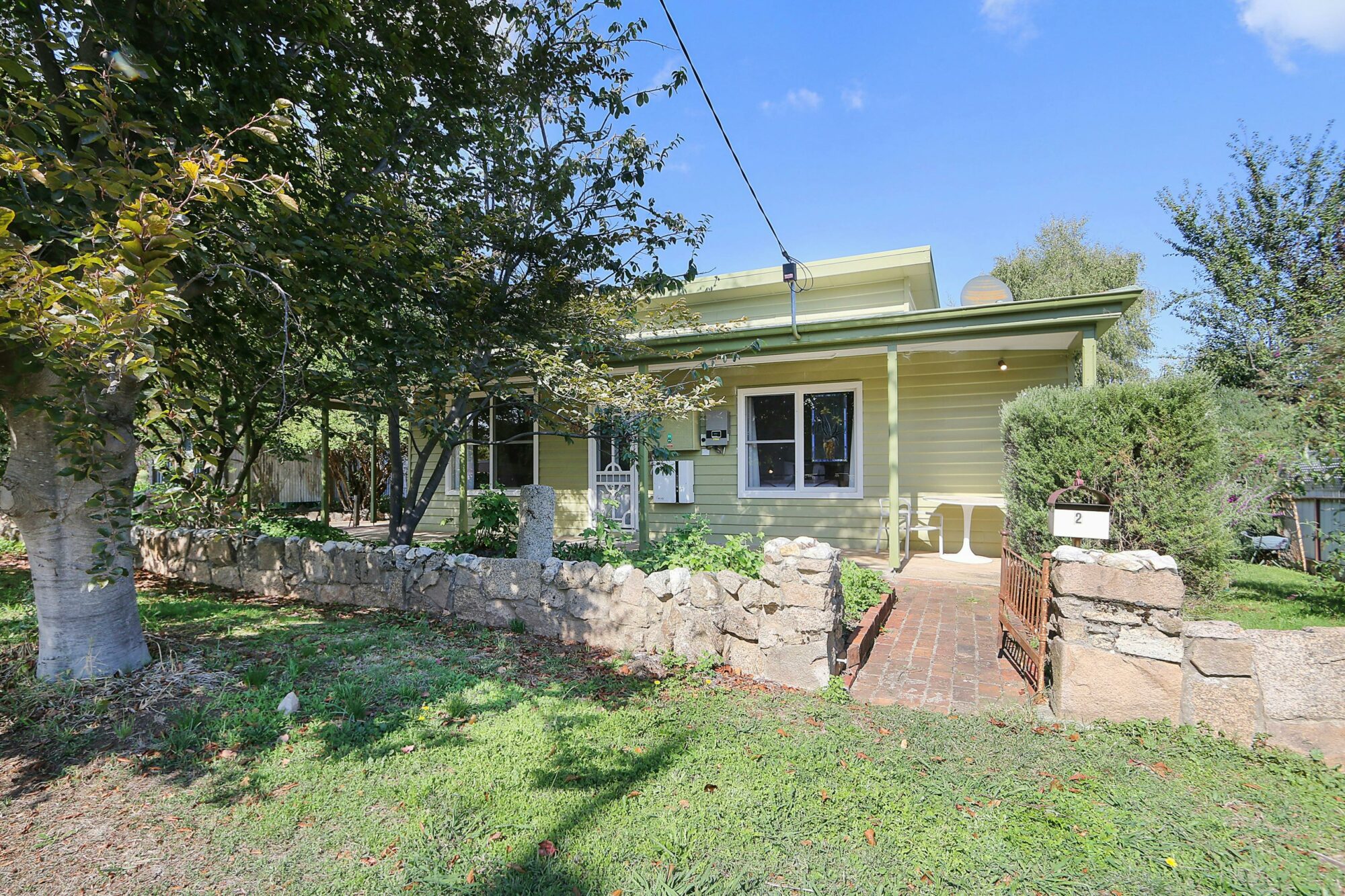 Front of Cottage with large tree and grassed area
